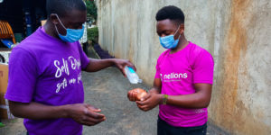 A Nellion's staff sanitizing another staff member