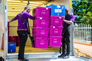 Two Nellions's professional staff moving crates